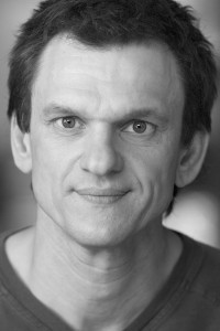 Alex Bisping as Orphan Production Designer in Beau Is Afraid (04/2023)