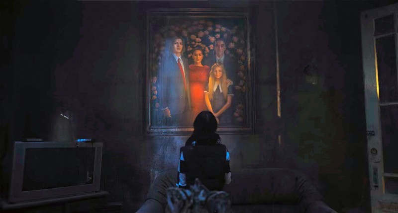 Wednesday looks at the Gates family portrait handing on the wall