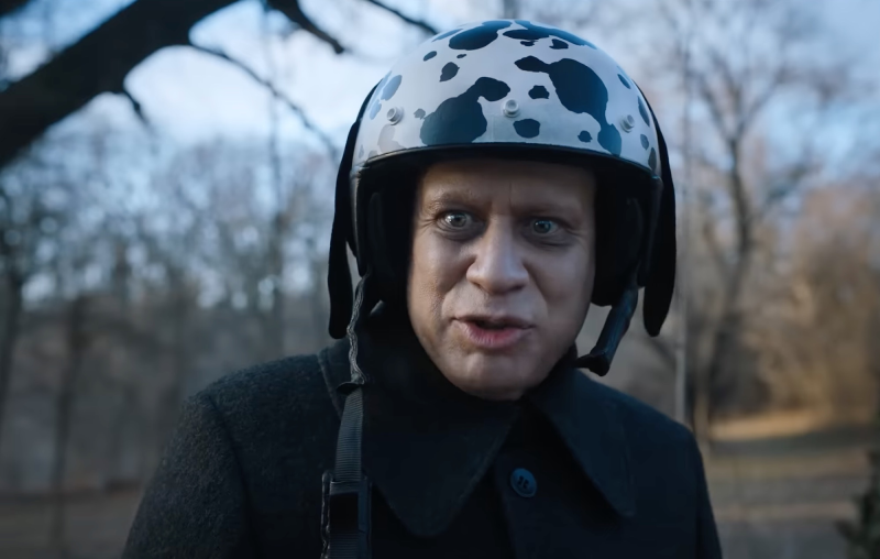 Uncle Fester wearing a cow print helmet