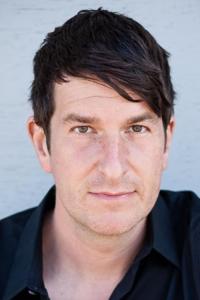Joe Cobden as News Correspondent (Brian Galloway) in Beau Is Afraid (04/2023)