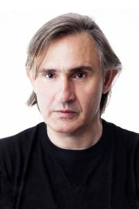 Akis Sakellariou as Kostas in The Bricklayer (12/2023)